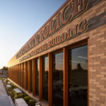 Exterior view of the St. Louis County Precinct 2 building signage at dusk