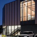 Exterior view of the St. Louis County Precinct 2 side, showcasing the copper panels and curtain wall at night